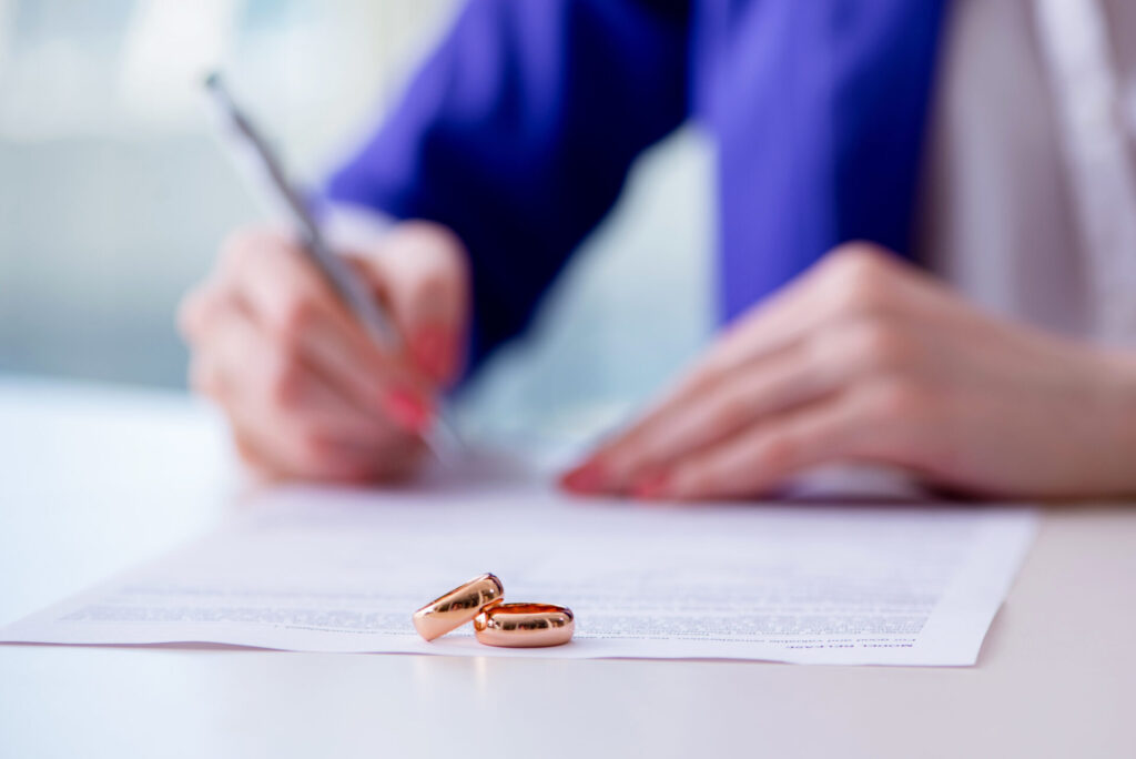 Prenups For Everyone, Not Just The Wealthy - Woman signing prenuptial agreement in court