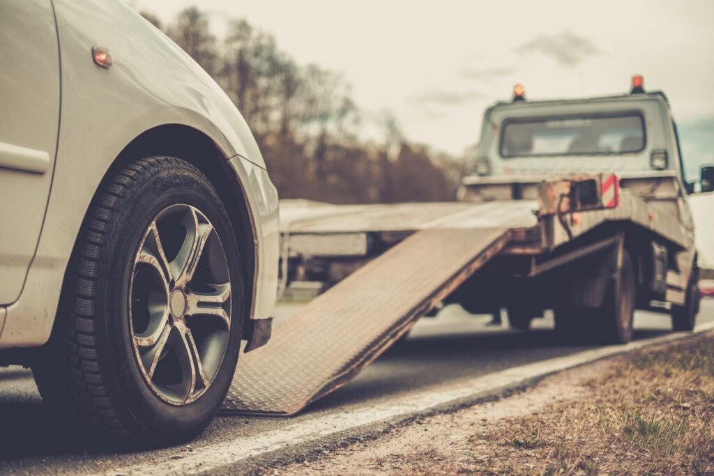 Car Accident Lawyer Hackensack, NJ - Loading broken car on a tow truck on a roadside