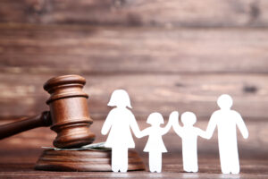 High-Income Child Support New Jersey - Family figures with gavel on brown wooden table