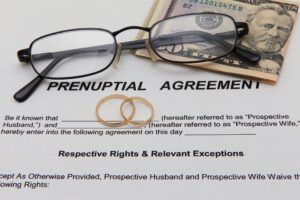 Prenuptial Agreements New Jersey - documents and money on table with glasses